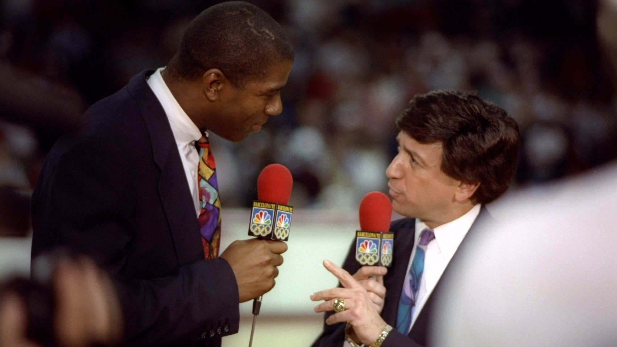 17 May 1992: NBC sportscaster Marv Albert and Earvin Magic Johnson talk during a game between the Chicago Bulls and the New York Knicks at the United Center in Chicago, Illinois.